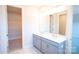 Bright bathroom boasts double sink vanity and walk-in closet with shelving at 219 Halemarg Dr, Belmont, NC 28012