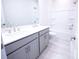 Bathroom featuring double sinks, white cabinets, shower, and tile flooring at 219 Halemarg Dr, Belmont, NC 28012