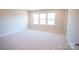 A carpeted bedroom area with 3 windows for great lighting at 219 Halemarg Dr, Belmont, NC 28012