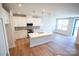 Open-concept kitchen boasts an island with quartz countertops and stainless steel appliances at 219 Halemarg Dr, Belmont, NC 28012