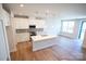 Open-concept kitchen boasts an island with quartz countertops and stainless steel appliances at 219 Halemarg Dr, Belmont, NC 28012