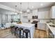 Bright kitchen features a large island with bar stool seating, pendant lighting, and stainless steel appliances at 2365 Hedgecliff Rd, Kannapolis, NC 28025