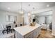 Open-concept kitchen boasts an island with barstool seating and pendant lighting flowing into the dining and living areas at 2365 Hedgecliff Rd, Kannapolis, NC 28025