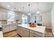 Well-lit kitchen features a central island with seating, stainless appliances, and seamless flow to the dining area at 2365 Hedgecliff Rd, Kannapolis, NC 28025