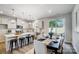 Bright open-concept kitchen with island seating flows into the dining area with sliding glass door to patio at 2365 Hedgecliff Rd, Kannapolis, NC 28025