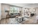 Bright living room boasts hardwood floors, large windows, and open access to a modern kitchen at 2365 Hedgecliff Rd, Kannapolis, NC 28025