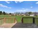 View from the back deck of the spacious, lush green backyard with distant homes at 238 Lippard Springs Cir, Statesville, NC 28677