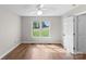 Sunny bedroom with wood flooring and a large window view at 238 Lippard Springs Cir, Statesville, NC 28677