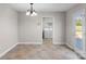 Open dining area features tiled floor and access to laundry room and outdoor deck at 238 Lippard Springs Cir, Statesville, NC 28677