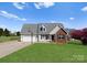 Charming single-Gathering home with a basketball hoop, well-kept lawn, and a brick-accented facade at 238 Lippard Springs Cir, Statesville, NC 28677