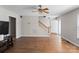 Bright living room featuring wood floors, a ceiling fan, and open doorway, creating a welcoming atmosphere at 238 Lippard Springs Cir, Statesville, NC 28677