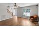 Inviting living room with beautiful wood floors, stairs, neutral walls and natural light from a large window at 238 Lippard Springs Cir, Statesville, NC 28677