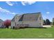 Rear exterior view featuring a wooden deck and a well-maintained lawn at 238 Lippard Springs Cir, Statesville, NC 28677