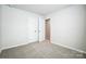 Neutral bedroom featuring an open closet, carpet flooring, and ample space at 2385 Hedgecliff Rd, Kannapolis, NC 28025