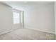 Neutral bedroom with window allowing ample natural light and soft carpet flooring at 2385 Hedgecliff Rd, Kannapolis, NC 28025