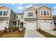 Charming townhome with well-manicured lawn, two-car garage, and appealing beige and brown color scheme at 2385 Hedgecliff Rd, Kannapolis, NC 28025