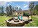 Backyard with firepit, outdoor seating, and brick patio at 306 Nance Rd, Charlotte, NC 28214