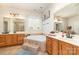 Bathroom featuring a soaking tub, dual vanities, and natural light at 306 Nance Rd, Charlotte, NC 28214