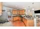 Spacious kitchen with wood cabinets, granite countertops, and view into the open-concept living space at 306 Nance Rd, Charlotte, NC 28214