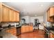 Well-equipped kitchen featuring wood cabinetry, granite countertops, and stainless steel appliances at 306 Nance Rd, Charlotte, NC 28214