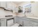 Bright kitchen with white cabinets, stainless steel sink, gas range, and window at 306 Nance Rd, Charlotte, NC 28214