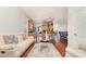 Open-concept living room with hardwood floors flowing into the kitchen and a comfortable sofa at 306 Nance Rd, Charlotte, NC 28214