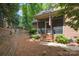 Exterior of home and backyard with a brick patio, screened porch, and landscaped yard at 310 Berkeley Rd, Rock Hill, SC 29732