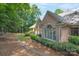 A serene backyard view of the home with lush landscaping and a stone patio at 310 Berkeley Rd, Rock Hill, SC 29732