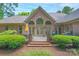 Beautiful backyard featuring a brick patio, lush landscaping, and an elegant exterior view of the home at 310 Berkeley Rd, Rock Hill, SC 29732