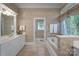 Bright bathroom featuring double sinks, wallpaper, and a soaking tub at 310 Berkeley Rd, Rock Hill, SC 29732
