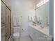 Bright bathroom featuring a glass enclosed shower, white cabinets, and a well lit vanity area at 310 Berkeley Rd, Rock Hill, SC 29732