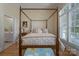 Cozy bedroom with four-poster bed and ensuite bathroom bathed in natural light from large windows at 310 Berkeley Rd, Rock Hill, SC 29732