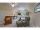 Bright bonus room with vaulted ceilings, fan, exercise bike and seating area for flexible living and recreation at 310 Berkeley Rd, Rock Hill, SC 29732