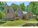 Stunning brick home with well-manicured lawn and mature trees offers timeless elegance and curb appeal at 310 Berkeley Rd, Rock Hill, SC 29732