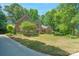Well maintained front lawn and mature trees surround this stately brick home at 310 Berkeley Rd, Rock Hill, SC 29732