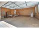 Garage interior with ample space, stairs, door, epoxy flooring, utility sink, and storage at 310 Berkeley Rd, Rock Hill, SC 29732