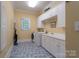 Functional laundry room featuring modern washer/dryer, ample storage, and utility sink at 310 Berkeley Rd, Rock Hill, SC 29732
