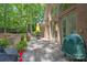Charming stone patio features an outdoor dining set with lush greenery all around at 310 Berkeley Rd, Rock Hill, SC 29732