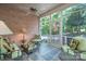 Cozy screened porch with slate flooring, brick wall and casual seating, perfect for relaxing outdoors at 310 Berkeley Rd, Rock Hill, SC 29732
