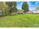 Expansive backyard featuring lush greenery and mature trees at 311 W Center Ave, Mooresville, NC 28115