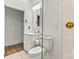 An elegant bathroom shows off the glass-enclosed shower and vanity with gold fixtures at 311 W Center Ave, Mooresville, NC 28115