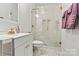 A modern bathroom features hexagon tile flooring and a glass-enclosed walk-in shower at 311 W Center Ave, Mooresville, NC 28115