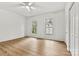 A bright bedroom features beautiful wood-look flooring and closet for ample storage space at 311 W Center Ave, Mooresville, NC 28115