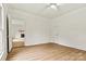 Bright bedroom featuring beautiful floors, ceiling fan, and neutral paint at 311 W Center Ave, Mooresville, NC 28115
