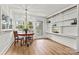 Cozy breakfast nook with a charming light fixture, built-in shelving, and natural light at 311 W Center Ave, Mooresville, NC 28115