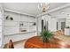 Charming breakfast nook with custom built-in shelves adjacent to kitchen at 311 W Center Ave, Mooresville, NC 28115