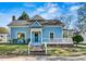 Charming blue home with a welcoming front porch and well-maintained lawn at 311 W Center Ave, Mooresville, NC 28115