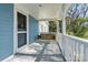 Inviting front porch with a charming swing and white railing, perfect for enjoying the outdoors at 311 W Center Ave, Mooresville, NC 28115