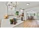 White kitchen featuring quartz countertops, stainless appliances, and an adjacent breakfast nook at 311 W Center Ave, Mooresville, NC 28115