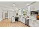 Bright open-concept kitchen with white cabinetry and stainless steel appliances at 311 W Center Ave, Mooresville, NC 28115